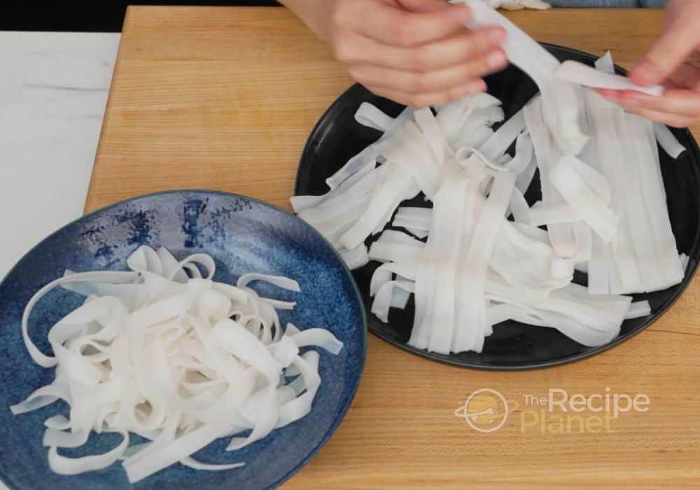 Cook rice noodles according to package instructions; drain and rinse under cold water. Cook rice noodles according to package instructions; drain and rinse under cold water.n