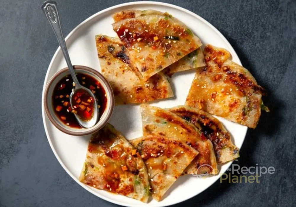 Cut into wedges and serve warm with soy dipping sauce Cut into wedges and serve warm with soy dipping sauce.n